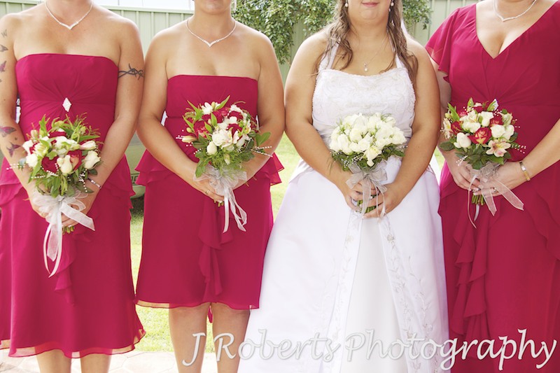 Bride and bridesmaids holding flowers - wedding photography sydney